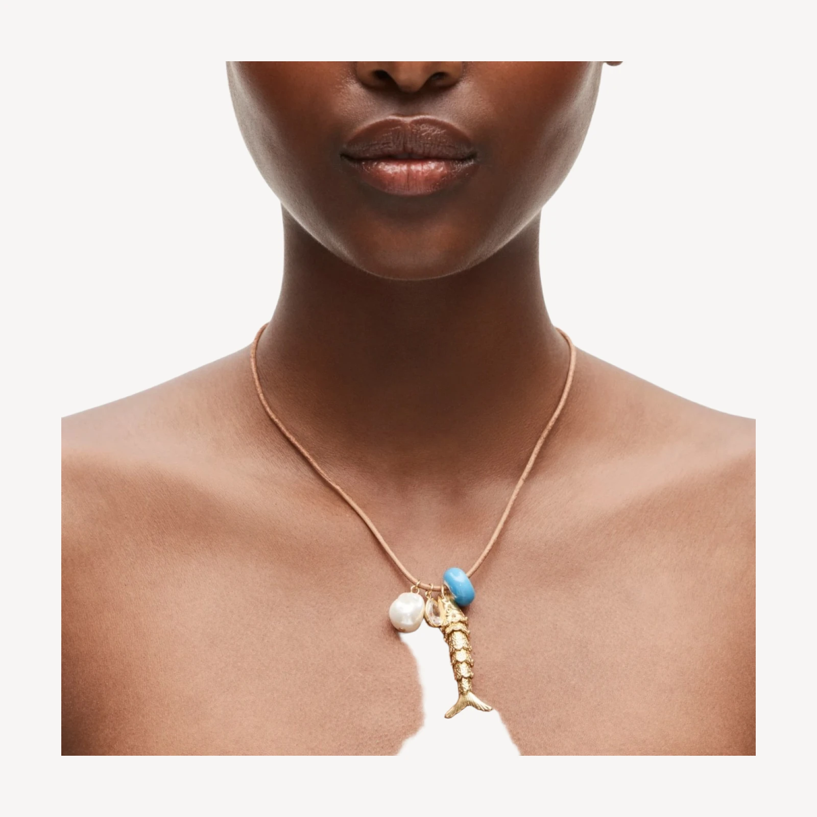 Fish pendant necklace on leather cord