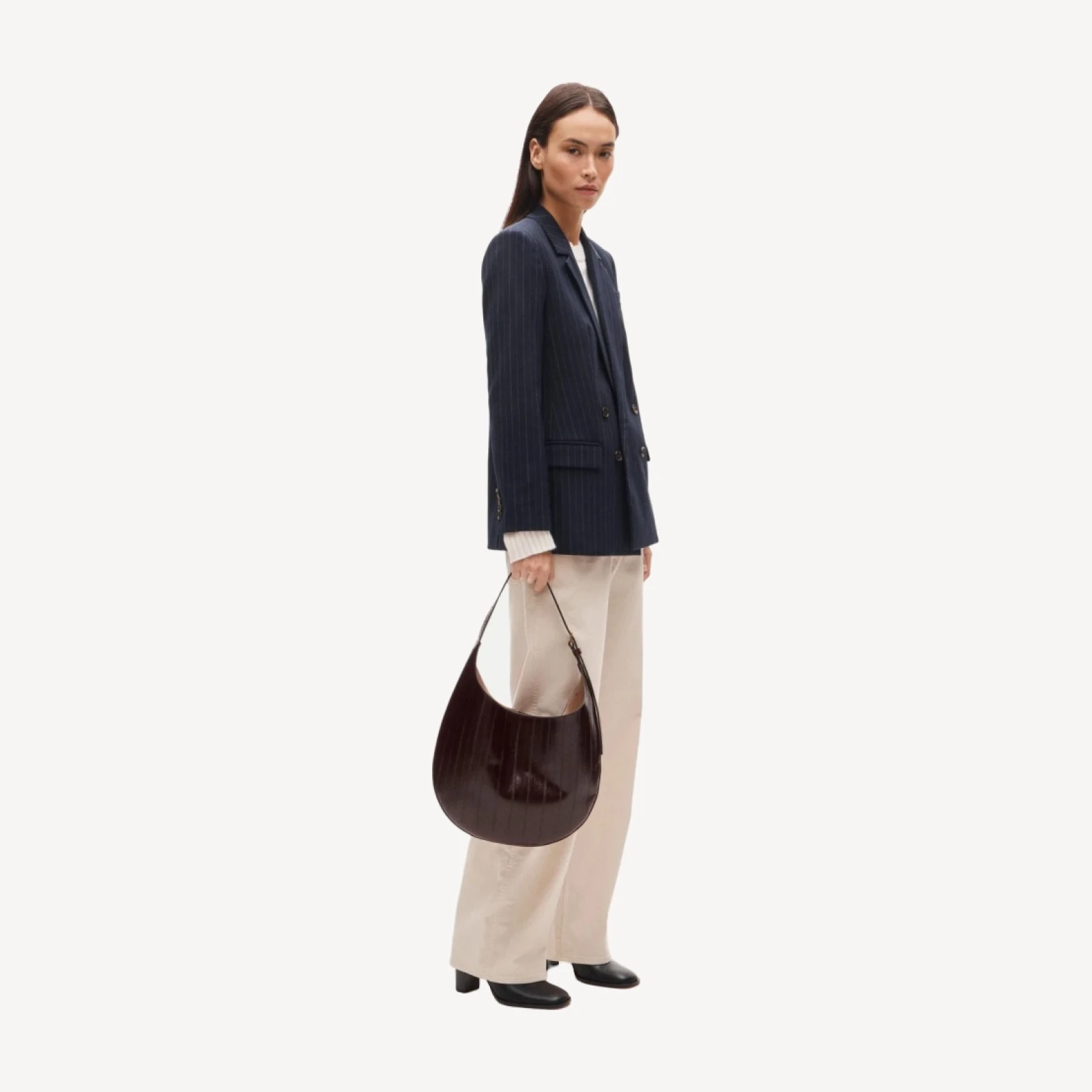 Round shoulder bag in eel-embossed leather