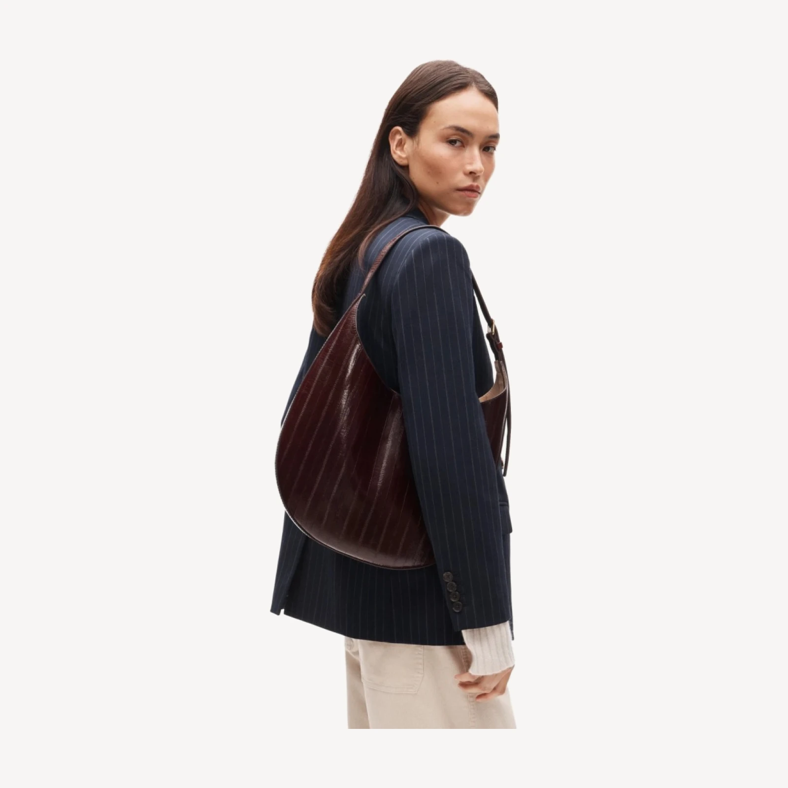 Round shoulder bag in eel-embossed leather