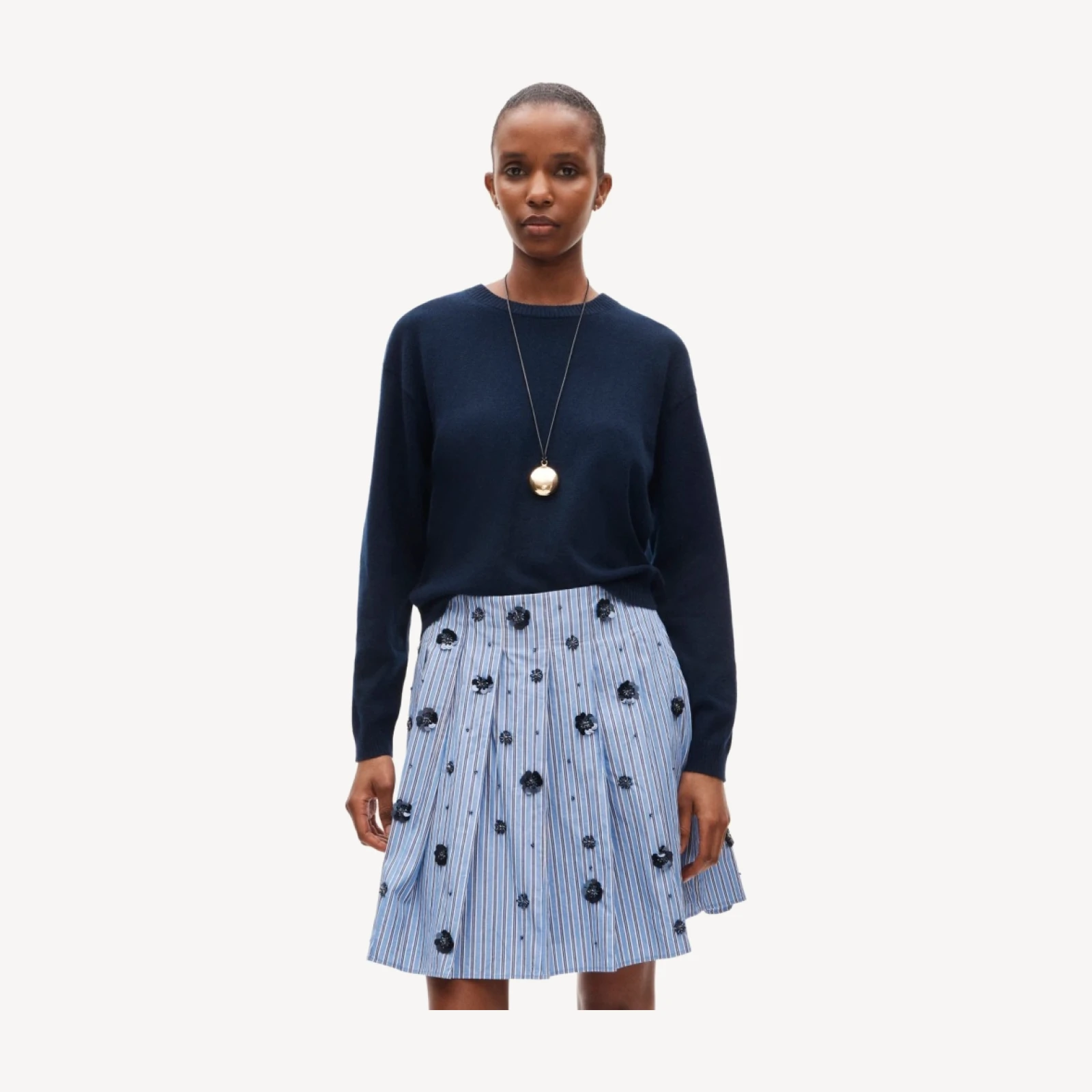 Pleated prep skirt in stripe with floral embellishments