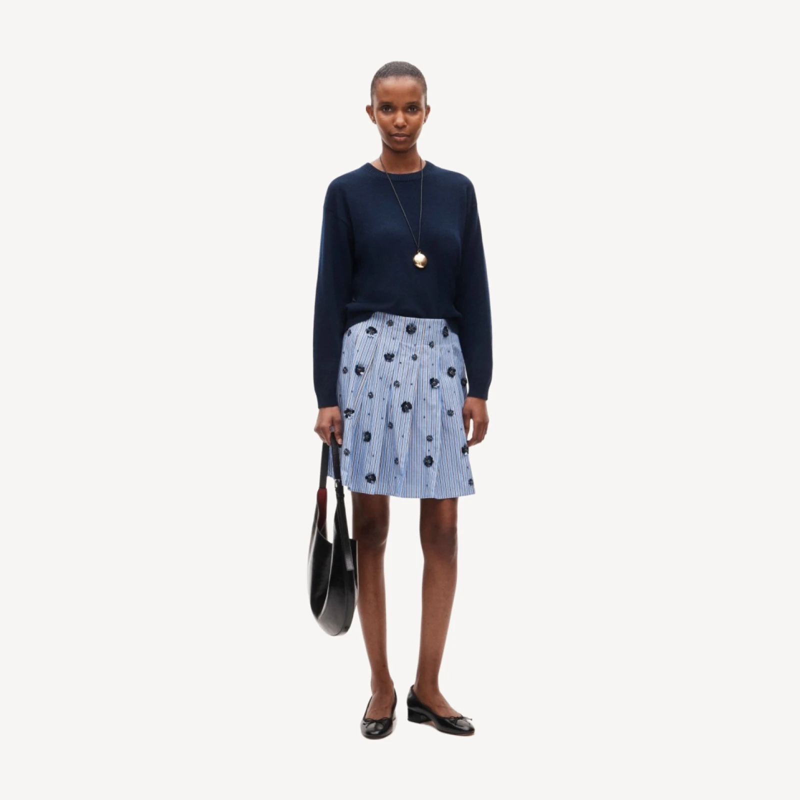 Pleated prep skirt in stripe with floral embellishments